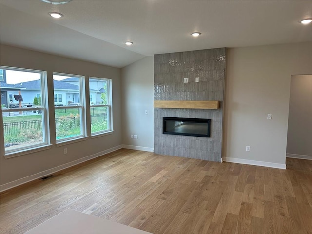 17752 Houston St, Gardner, KS 66030 - unfurnished living room featuring wood finished floors, a fireplace, lofted ceiling, and recessed lighting