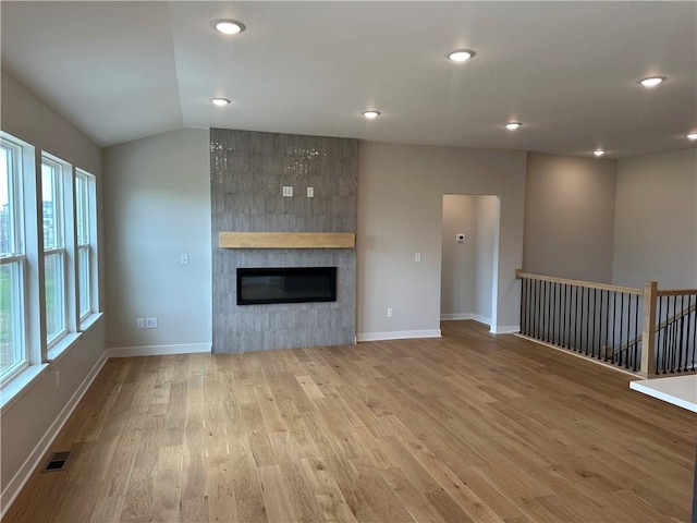 17752 Houston St, Gardner, KS 66030 - unfurnished living room featuring wood finished floors, a fireplace, recessed lighting, and vaulted ceiling