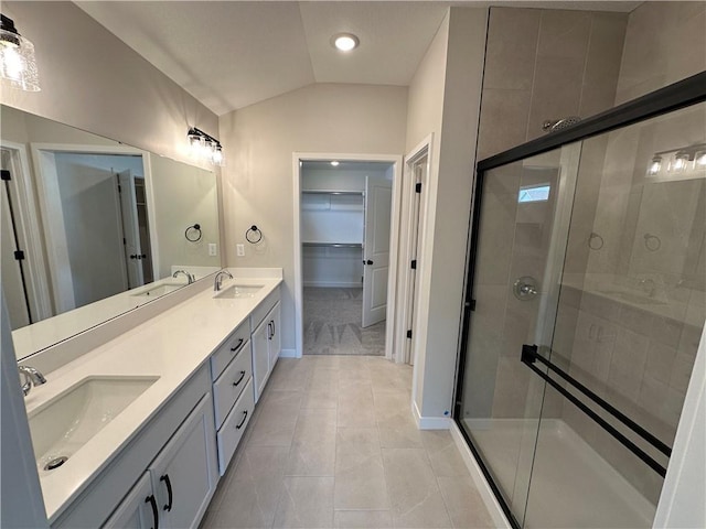 17752 Houston St, Gardner, KS 66030 - bathroom with double vanity, a shower stall, vaulted ceiling, a walk in closet, and tile patterned floors