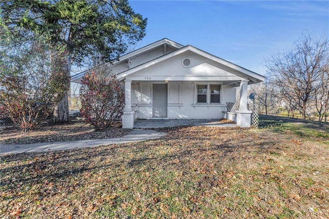 view of front of home with a porch and a front yard