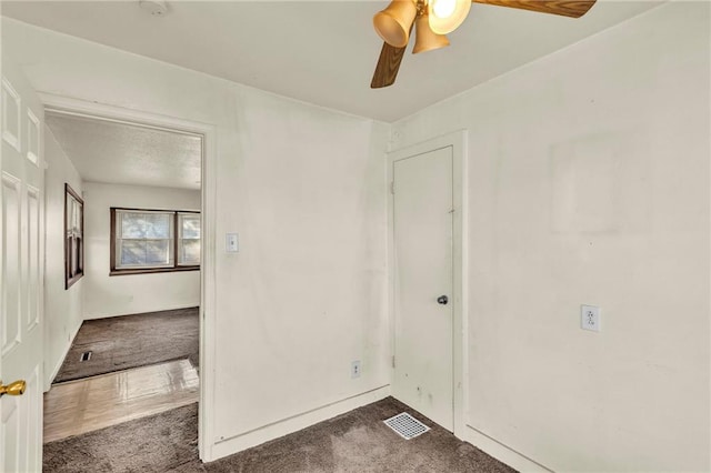 empty room featuring carpet and ceiling fan