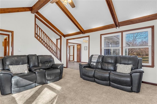 carpeted living room featuring beamed ceiling, ceiling fan, and high vaulted ceiling