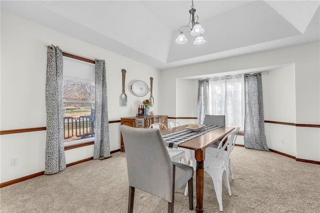 dining space featuring light carpet, lofted ceiling, and a notable chandelier