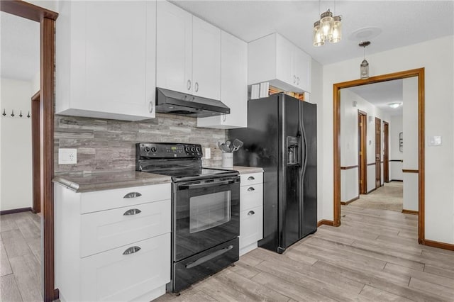 kitchen with black appliances, white cabinets, light wood-type flooring, and backsplash