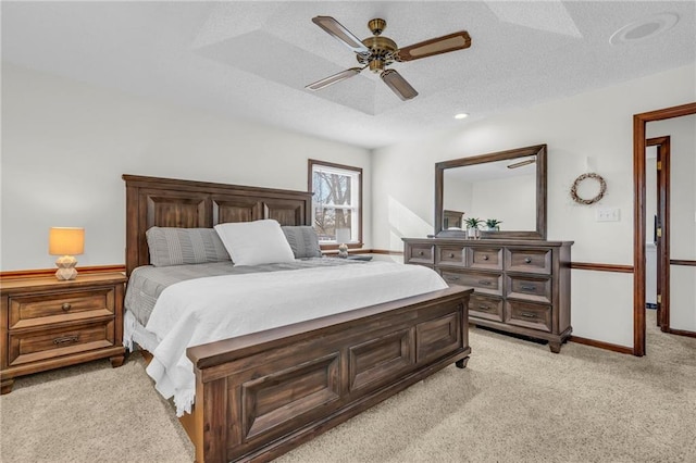 carpeted bedroom with ceiling fan and a textured ceiling