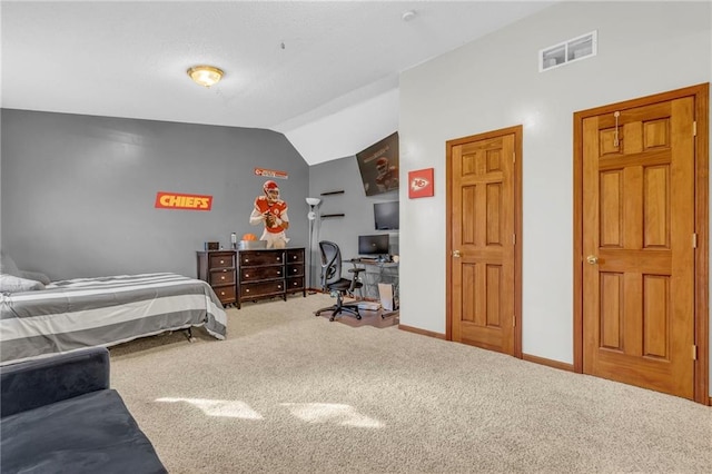 carpeted bedroom with lofted ceiling