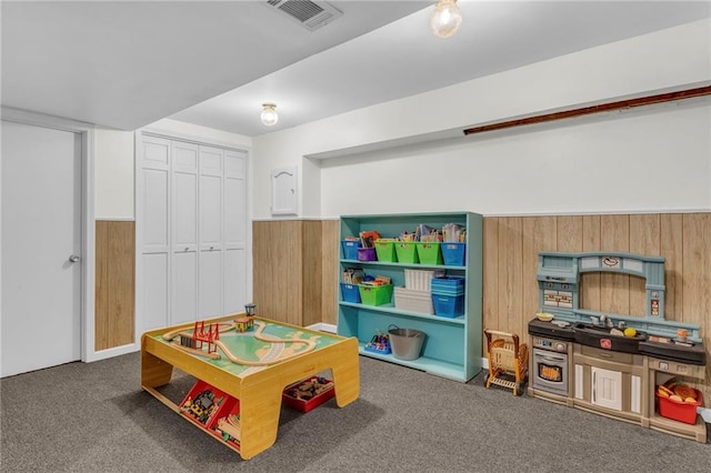 playroom with wood walls and carpet