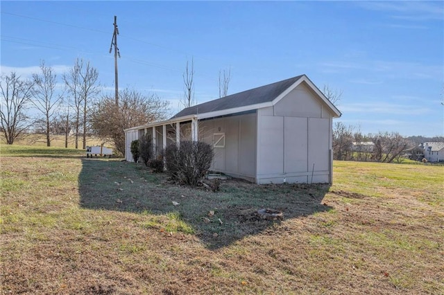 view of outdoor structure featuring a lawn