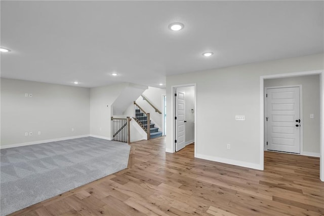 basement with light hardwood / wood-style flooring