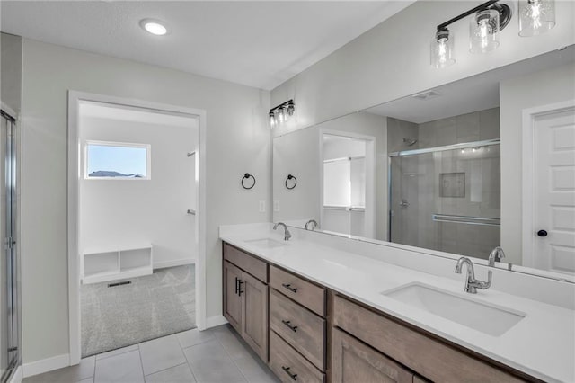 bathroom with walk in shower, tile patterned floors, and vanity