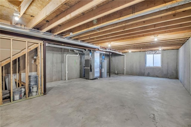 basement featuring water heater and heating unit