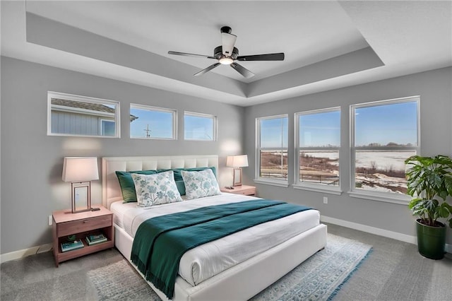 17744 Houston St, Gardner, KS 66030 - bedroom featuring a tray ceiling, baseboards, carpet floors, and ceiling fan