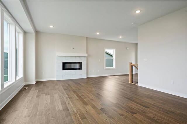 17744 Houston St, Gardner, KS 66030 - unfurnished living room with dark wood-style flooring, recessed lighting, a fireplace, and baseboards