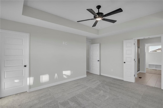 17744 Houston St, Gardner, KS 66030 - unfurnished bedroom featuring carpet, baseboards, a raised ceiling, and ceiling fan