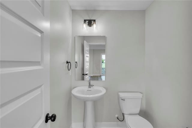 17744 Houston St, Gardner, KS 66030 - bathroom with toilet, a sink, and baseboards