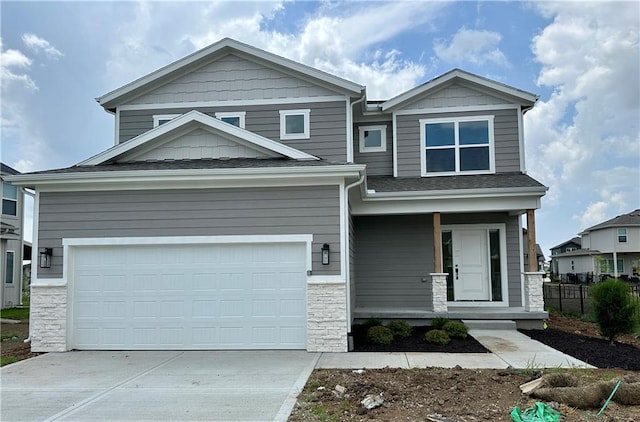 17744 Houston St, Gardner, KS 66030 - craftsman-style home featuring covered porch, driveway, stone siding, and roof with shingles