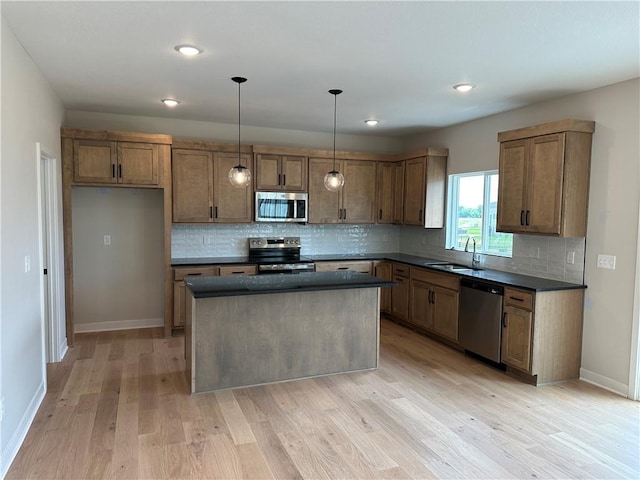 17744 Houston St, Gardner, KS 66030 - kitchen featuring appliances with stainless steel finishes, dark countertops, light wood finished floors, tasteful backsplash, and recessed lighting