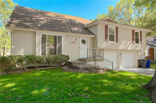 tri-level home with a front yard and a garage