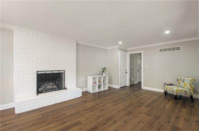 living area featuring a fireplace, a textured ceiling, dark hardwood / wood-style floors, and crown molding