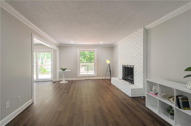 unfurnished living room with a textured ceiling, dark hardwood / wood-style flooring, a brick fireplace, and crown molding