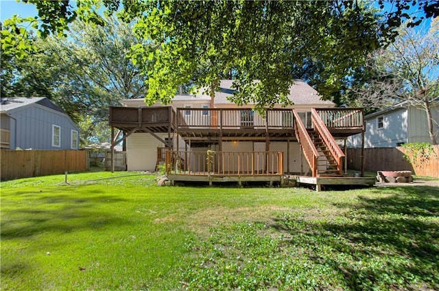 rear view of house with a lawn and a deck