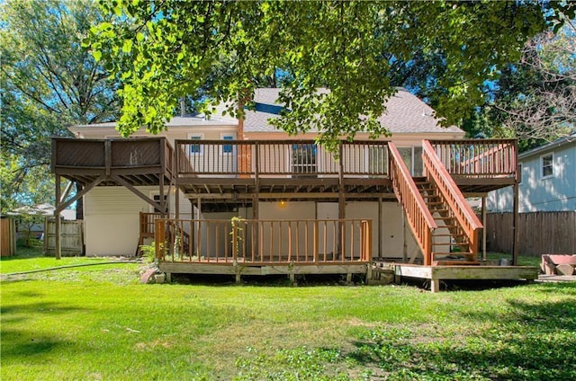 back of property featuring a yard and a wooden deck