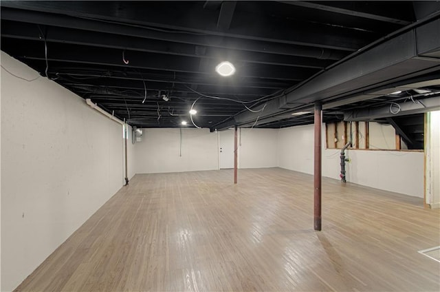 basement with hardwood / wood-style floors