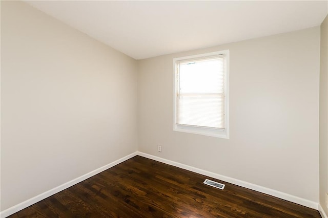 empty room featuring dark hardwood / wood-style flooring