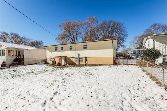 view of snow covered rear of property