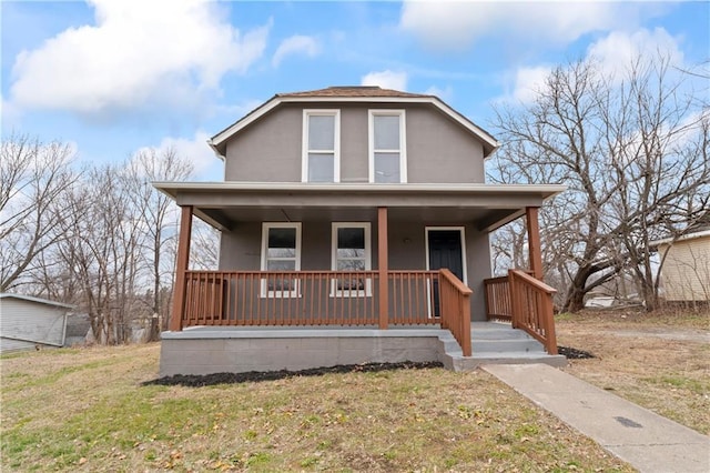 view of front of property with covered porch and a front lawn