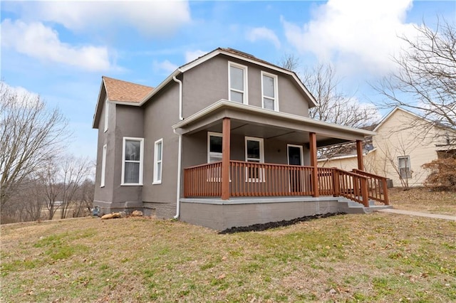 view of front facade featuring covered porch and a front yard