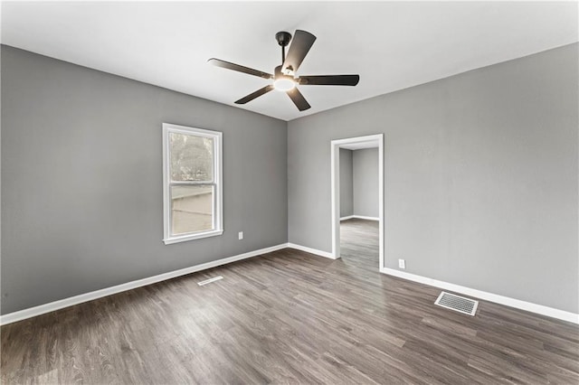 spare room featuring ceiling fan and dark hardwood / wood-style floors