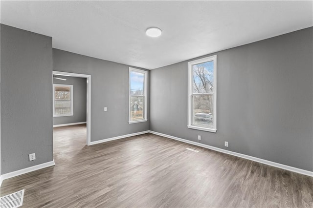 empty room with dark hardwood / wood-style flooring