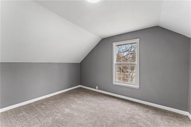 bonus room featuring carpet and vaulted ceiling