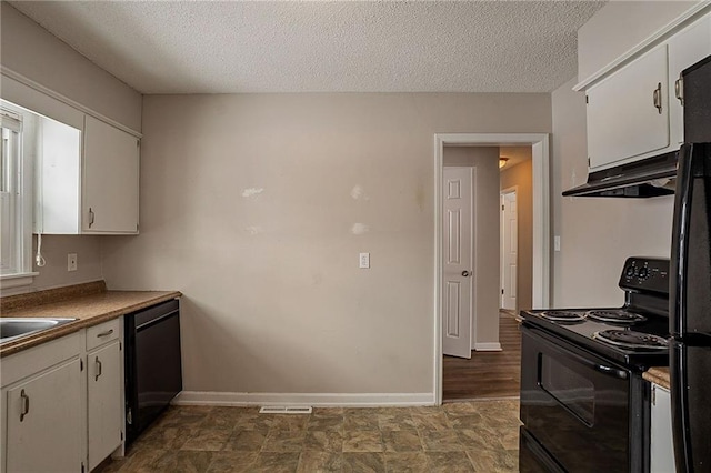 kitchen with white cabinets, black appliances, and a textured ceiling