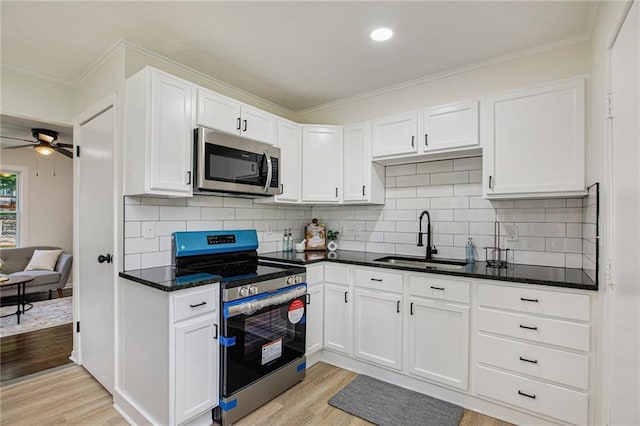 kitchen with sink, white cabinetry, and stainless steel appliances