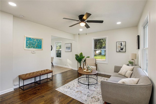 living room with ceiling fan and dark hardwood / wood-style floors