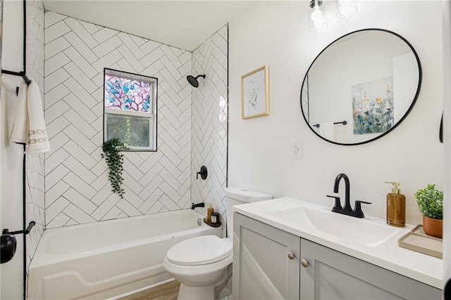 full bathroom featuring vanity, toilet, and tiled shower / bath