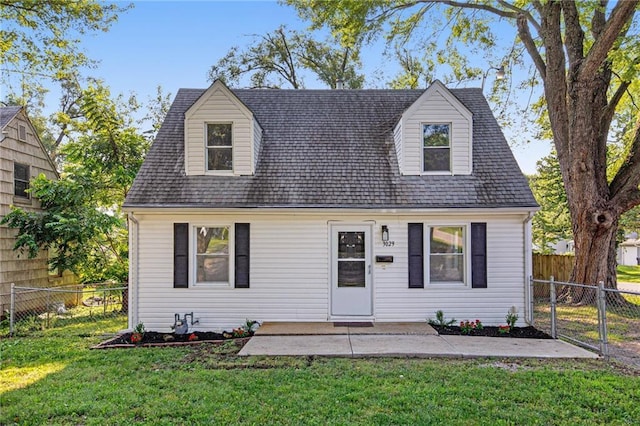 cape cod-style house featuring a patio area and a front lawn