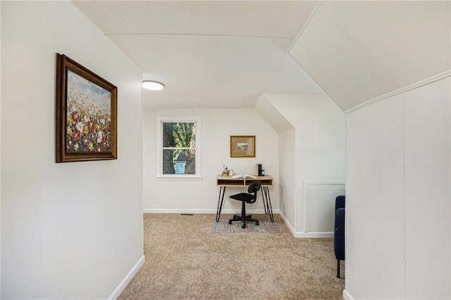 carpeted office featuring vaulted ceiling