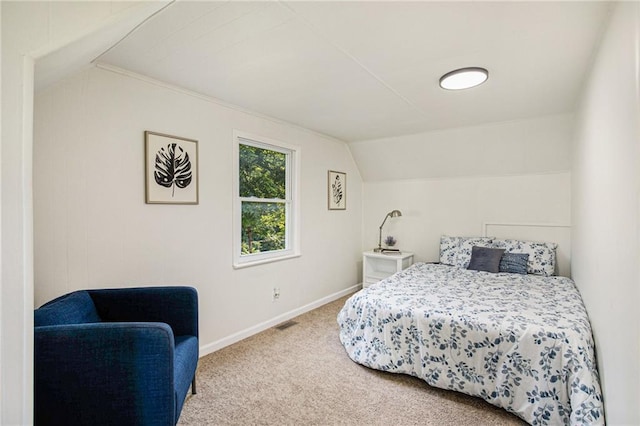 carpeted bedroom with vaulted ceiling