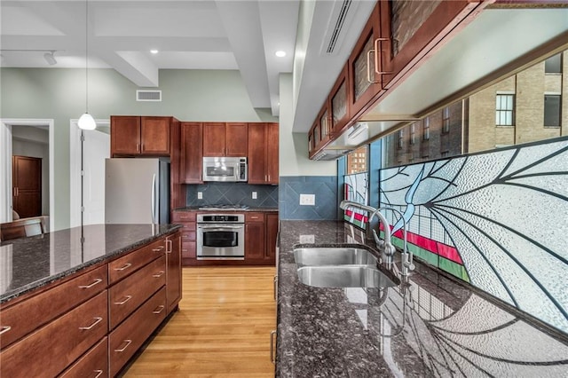 kitchen with light wood-type flooring, backsplash, stainless steel appliances, sink, and beam ceiling