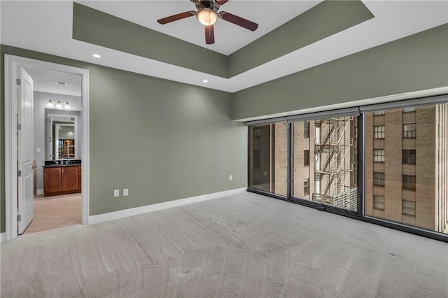 carpeted empty room featuring ceiling fan