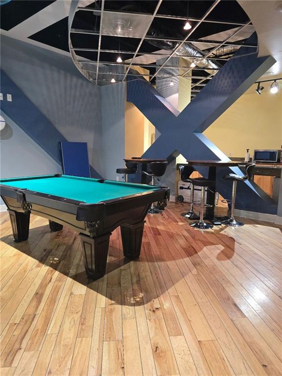 recreation room with hardwood / wood-style floors and pool table