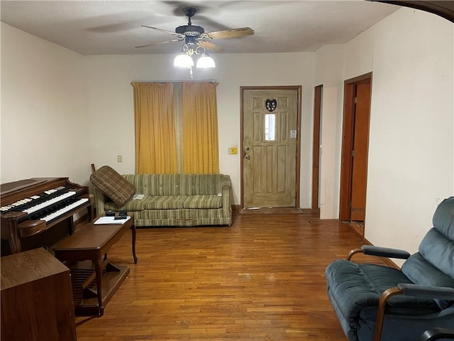 living room featuring ceiling fan and wood finished floors