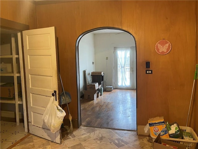 interior space with wooden walls and arched walkways