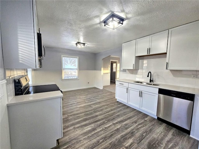 kitchen featuring appliances with stainless steel finishes, dark hardwood / wood-style floors, white cabinetry, and tasteful backsplash