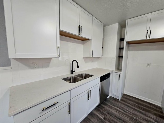 kitchen with backsplash, white cabinets, sink, stainless steel dishwasher, and dark hardwood / wood-style flooring