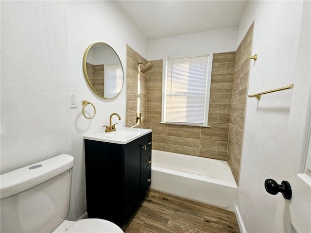 full bathroom with hardwood / wood-style flooring, vanity, toilet, and tiled shower / bath combo