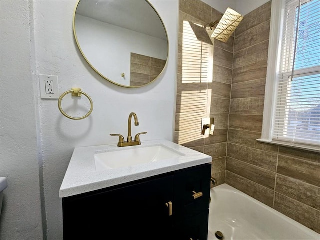 bathroom with vanity, bathing tub / shower combination, and plenty of natural light